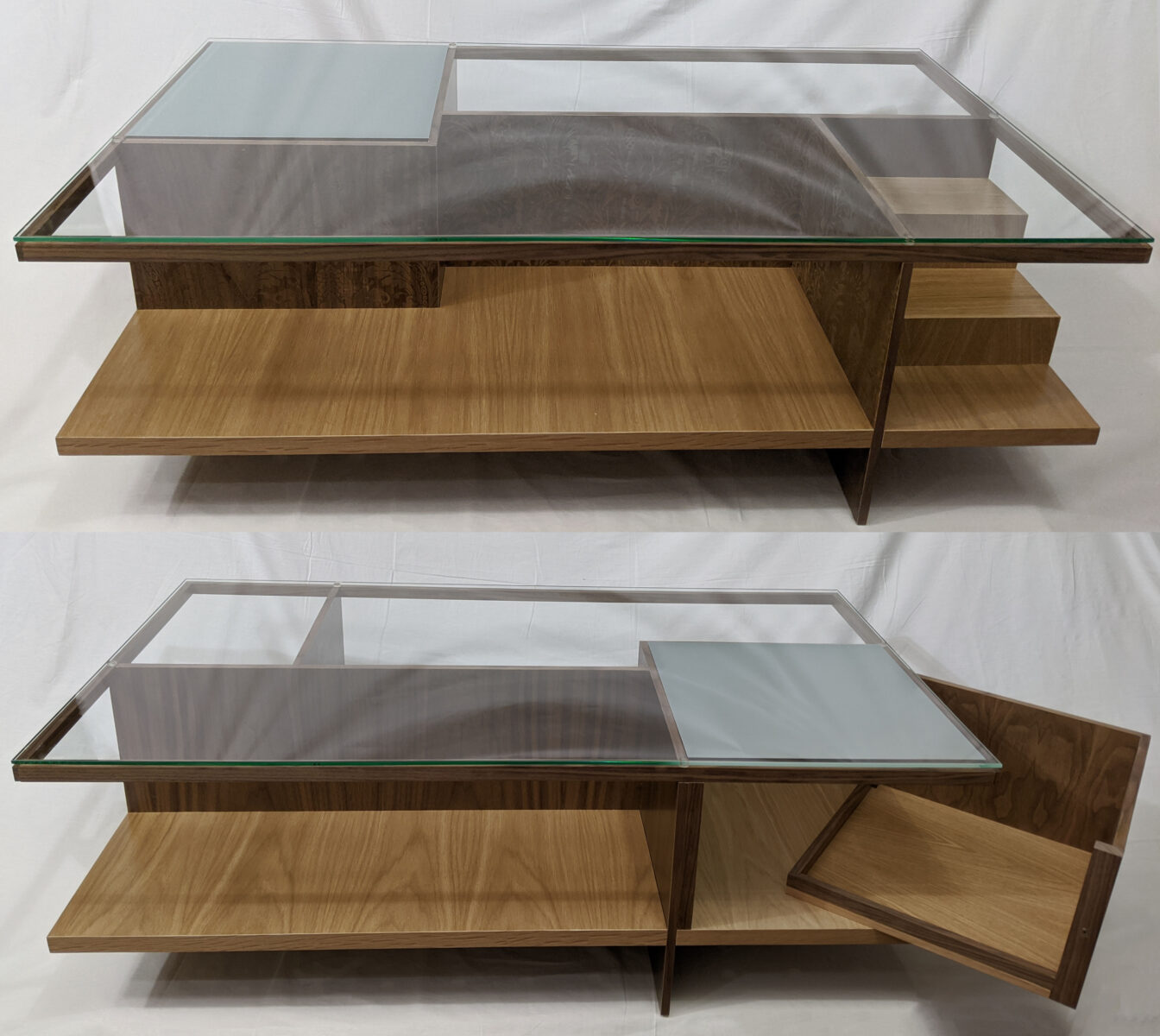 Two vertically stacked  images of a geometric wooden coffee table, displayed from two sides. It is rectangular with a glass top that is fogged in a single corner; the four table legs–made of dark brown wood–are slotted into the sides of the light brown table base, creating what are essentially walls that are visible through the top. The top image shows two inner sections of the table: the larger space on the left is a fat “L” shape and the section on the right is a small rectangle with two stair-like steps made from the same light brown wood as the table base. The bottom image shows the other side of the table; the fogged square is now the front right corner of the table top and is above the large hidden compartment that sits partially open, and the left section is a long rectangular space. 