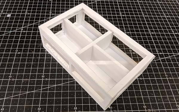 Side 2 of foam core table model E, the crossed interior frame cuts through the entire table, creating four “room” sections within it.