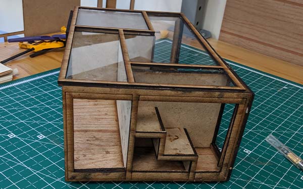 Side 2 of the laser cut wooden table shows the stair “room” from the side. The stairs are open with storage space below, and the space to the left is a long rectangular section.